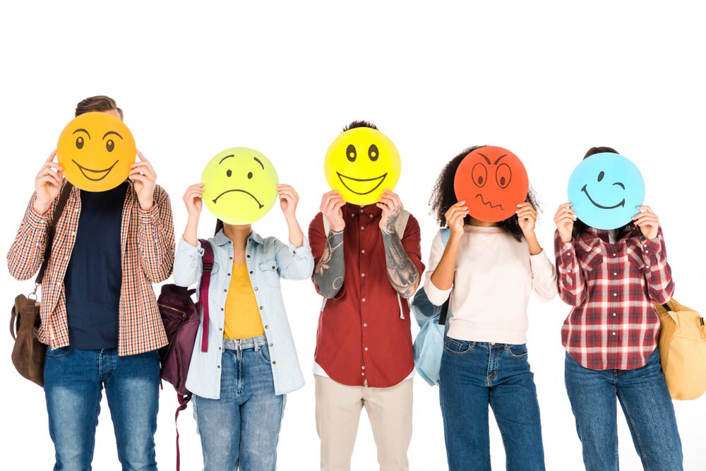 group of people standing and showing emotions on cards isolated on white
