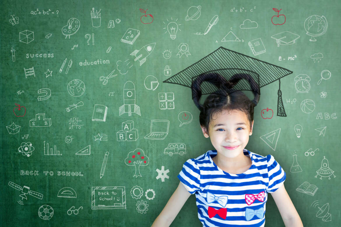 Smart educated school kid student with graduation hat doodle on chalkboard representing adolescent brain development