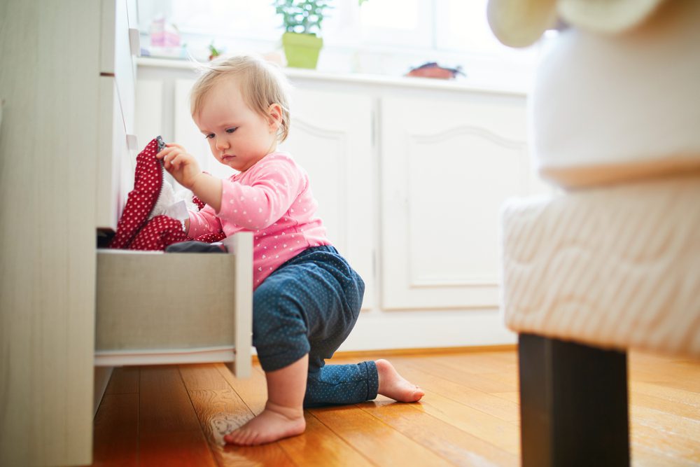 Baby exploring things in bedroom