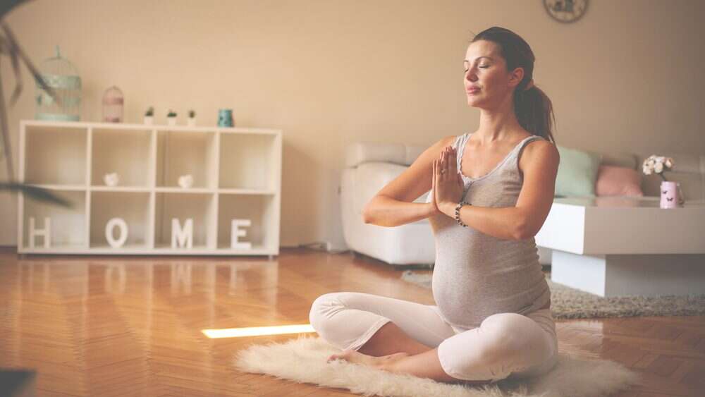 Pregnant women practicing yoga for better health